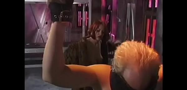  Sultry redhead dominatrix restrains and punishes pale white man in BDSM chamber